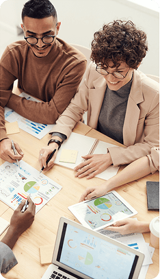 Payroll advisors reviewing reports at a table