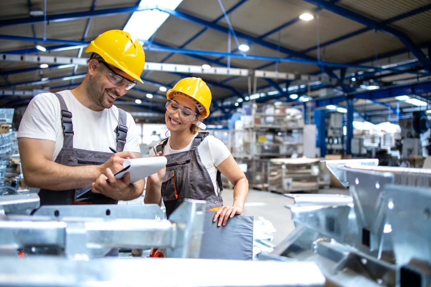 Manufacturing workers reviewing production details on the factory floor
